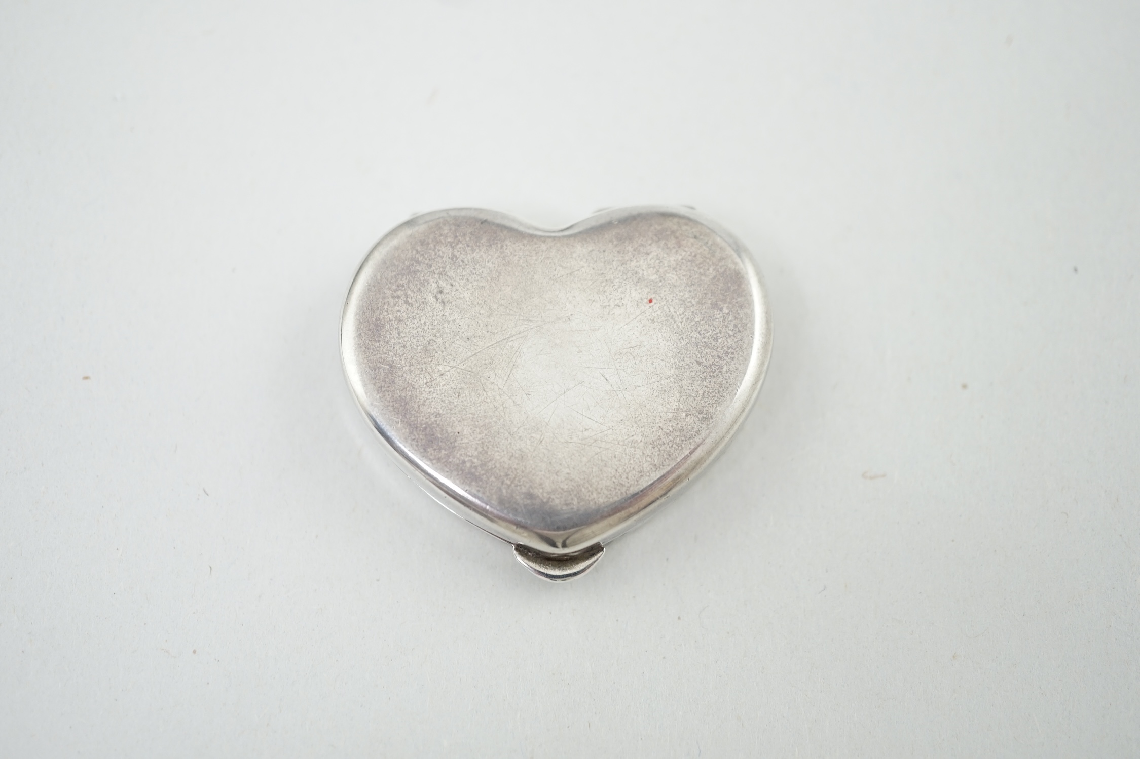 A modern Cartier sterling silver and polychrome enamel heart shaped pill box